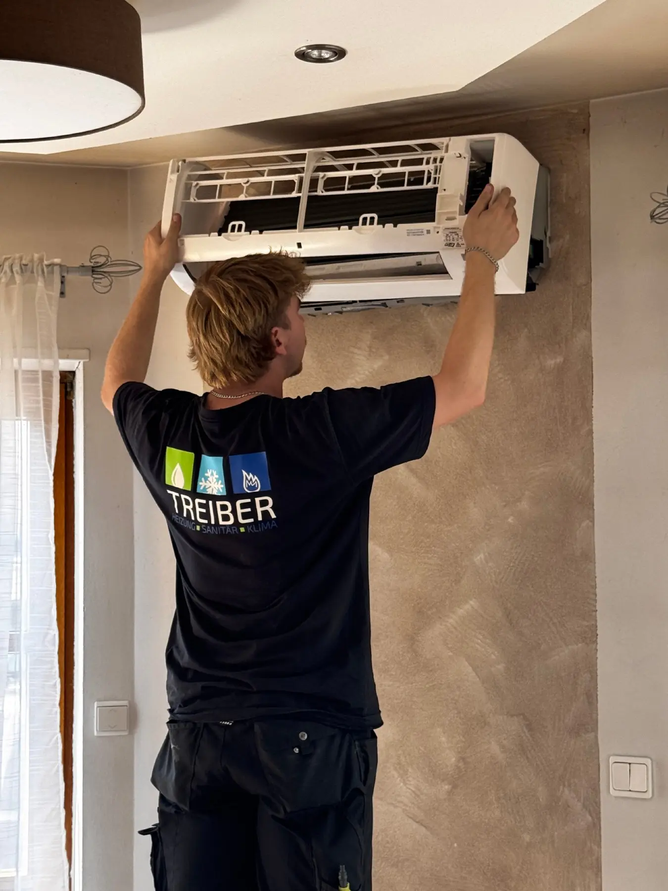 Mitarbeiter von Treiber Haustechnik bei der fachgerechten Montage einer Klimaanlage